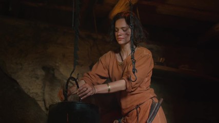 Dressed in Medieval Clothing Woman Cooking a Meal on Fire. Life of Civilian People at Village. Medieval Reenactment.
Shot on RED Cinema Camera in 4K (UHD).