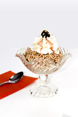 VERMICELLES SWISS DESSERT. CHESTNUT WITH CREAM IN GLASS CUP ON WHITE BACKGROUND