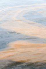Polluted water, oil, sludge, waste; colorful abstract background.