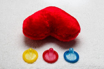 Colorful condoms and red heart