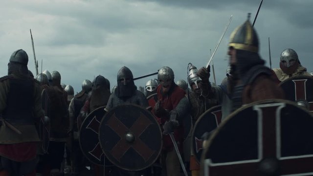 Army of Vikings are Raising Swords and Crying Before Battle. Shot on RED Cinema Camera in 4K (UHD).