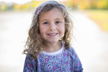 Little girl smiles at the camera.
