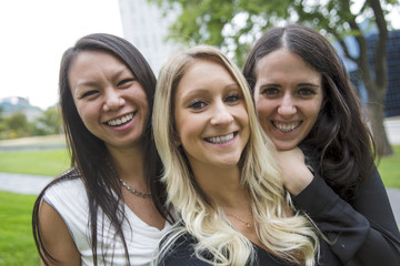 Three young good girl friend people in the city