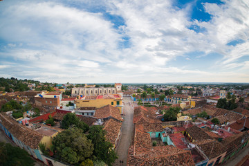 Fototapeta na wymiar Bird's-eye view from main chapel to roofs of ancient houses, central square, buildings and streets in the city center at summer sunny day