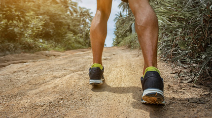 Runner feet running on path. Closeup on shoe