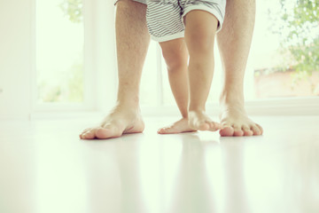 Parenting feet with baby walking first steps