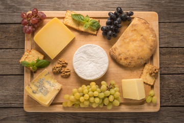  Cheese with grapes, walnuts and cracker on a table
