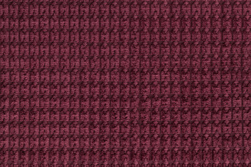 Dark red background from soft fleecy fabric close up. Texture of textiles macro