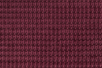 Fototapeta premium Dark red background from soft fleecy fabric close up. Texture of textiles macro