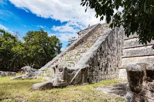 serpent sculpture at the base of Osario staircase, chichen itza, mexico