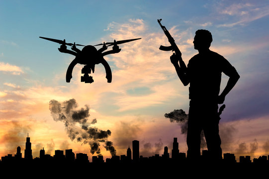 Silhouette flying reconnaissance drone over city in a smoke and a terrorist