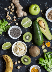 Green smoothie ingredients. Cooking healthy detox smoothies. On a dark background, top view