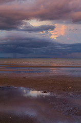 a cloudy sunset in a beach scene