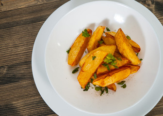potato in a bowl on wooden background. top view