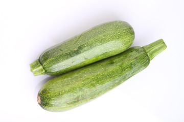 two zucchini on a white background