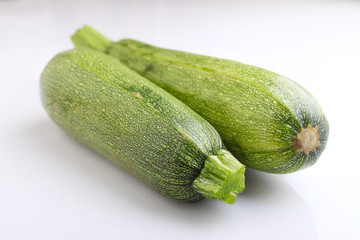 two zucchini on a white background