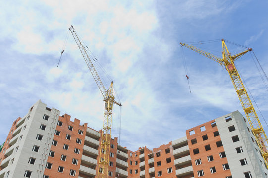Construction area: two cranes and incomplete high-riser