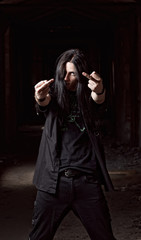 Long-haired young man making offensive gesture (middle fingers)