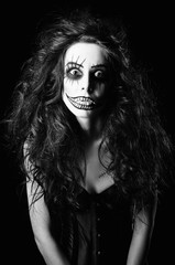 Beautiful young woman in the image of sad gothic freak clown. Black and white