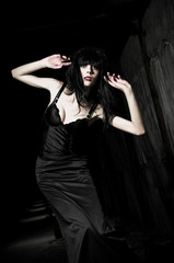 Beautiful goth girl among the darkness