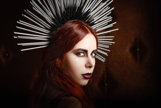 Closeup portrait of cute gothic girl wearing spiked headgear