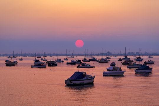 Fototapeta Serene sunset over boats at Sandbanks, Poole, Dorset near Bourne