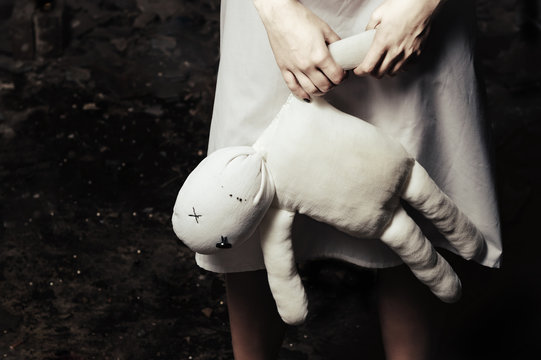 Horror style shot: moppet doll in someone's hands