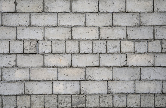 Серая каменная стена. Белые кирпичи текстура