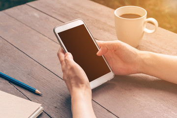 Close up hand asian woman using phone in coffee shop and sunligh