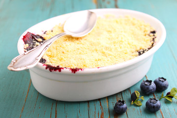 crumble with blueberry, bilberry in white plate