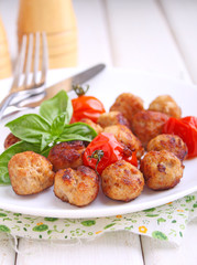Meatballs with tomato in a white dish on a white background. selective focus.