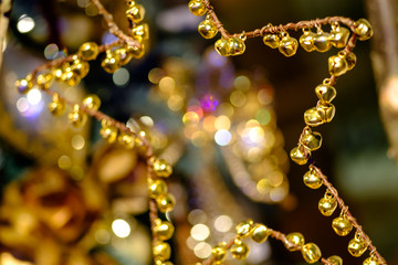 Golden Christmas star of jingle bells - a beautiful abstract background.