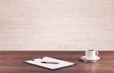 Office desk closeup with white brick wall