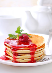 Pancake with berries blueberries in a plate on a white background