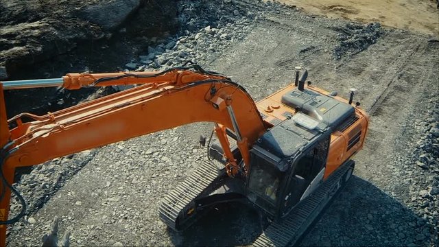 Aerial drone shot of a excavator working in construction yard
