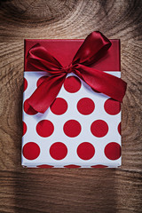 Red birthday present on wooden board holidays concept