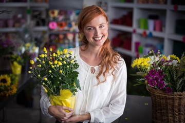 Female florist holding flower bouquet