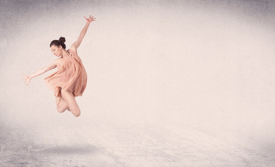 Modern ballet dancer performing art jump with empty background