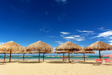 Palm parasol on the beach in a sunny day