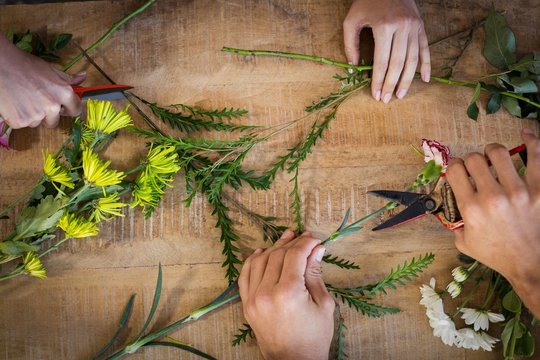 Hands of florist preparing flower bouquet