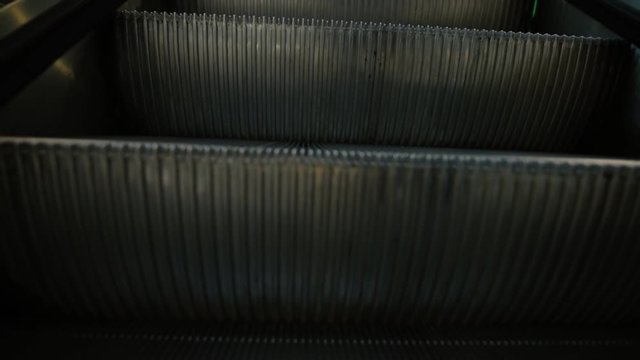POV - I go on escalator in mall, blurred focus
