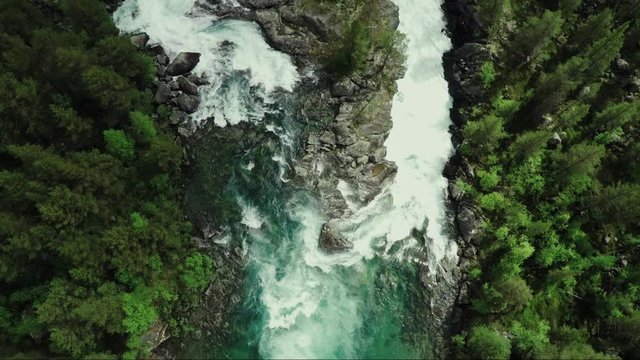 Top Down view of Fast Moving River with Rapids Surrounded by Pine Forest. Shot in Norway