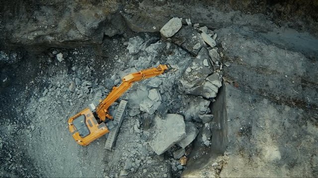 Aerial drone shot of a excavator working in construction yard