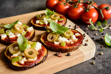 Eggplant pizzas with tomato sauce, cheese, pepper and olives