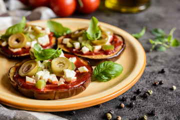 Eggplant pizzas with tomato sauce, cheese, pepper and olives