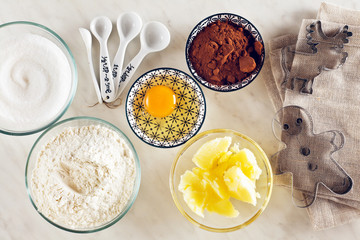 Ingredients for baking on a white marble table : flour, eggs, co