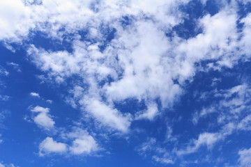 Blue sky background with white clouds. The vast blue sky and clouds sky on sunny day. White fluffy clouds in the blue sky.