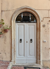Old wooden door in a stone house Italian