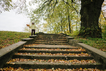 Little girl in the autumn park.stairs