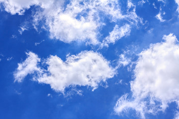 Blue sky background with white clouds. The vast blue sky and clouds sky on sunny day. White fluffy clouds in the blue sky.